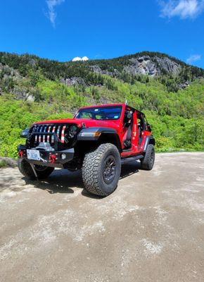 Off-road Jeep with top down parked in scenic outdoor area